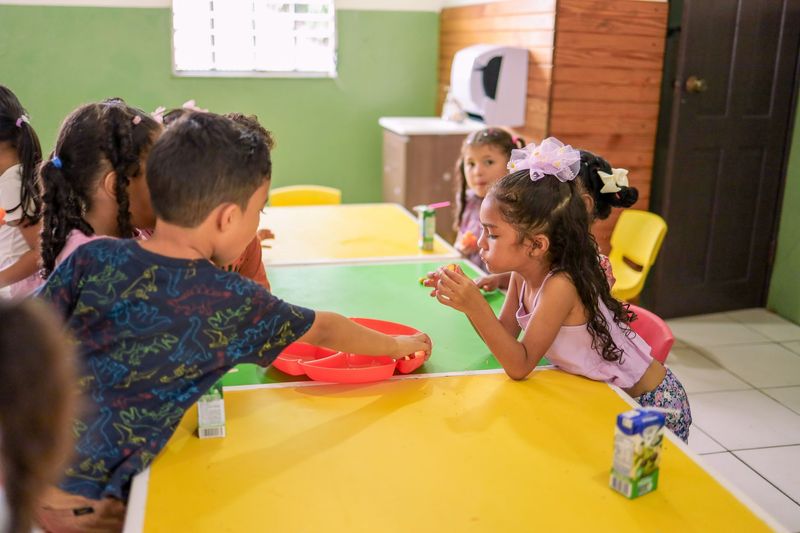 Children exploring simple musical instruments during daycare circle time