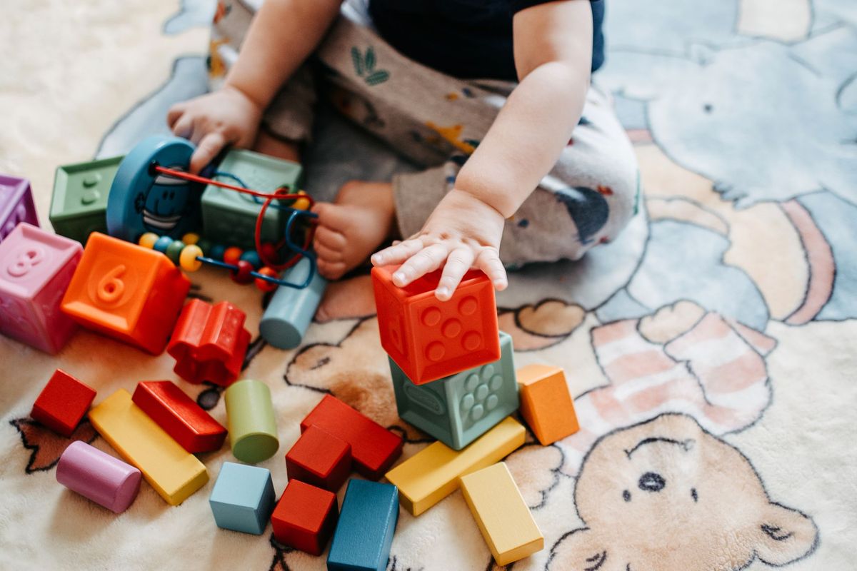 Smiling toddler playing in a bright, welcoming in-home daycare in Grapevine