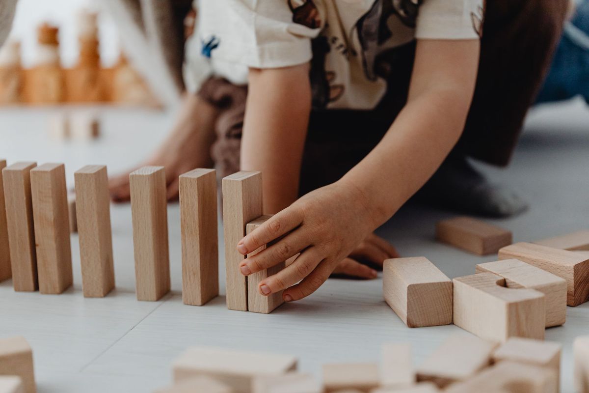Young children cooperatively building with colorful blocks in a welcoming daycare playroom