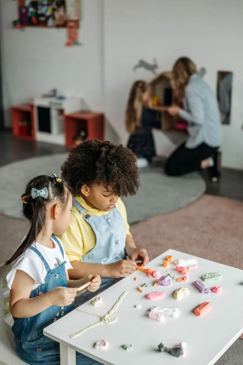 Toddler exploring a hands-on sensory activity at an in-home daycare